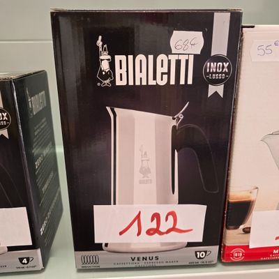 two boxes of coffee on a shelf in a store