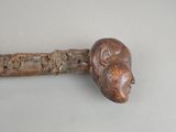 a wooden stick with a carved head on it