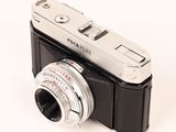 a silver and black camera with a silver lens