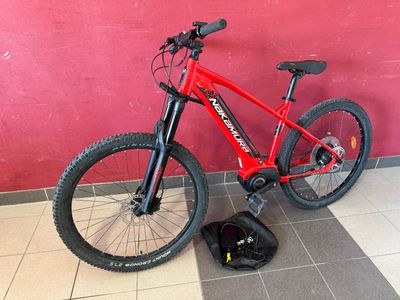 a bike that is sitting on the ground next to a bag