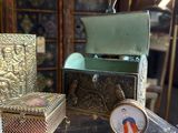 a glass display case with a clock and a box on it