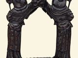 a statue of two women standing in front of a mirror