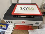 a printer sitting on top of a desk with a printer next to it