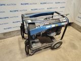 an image of a portable generator sits on a dolly in front of a wall