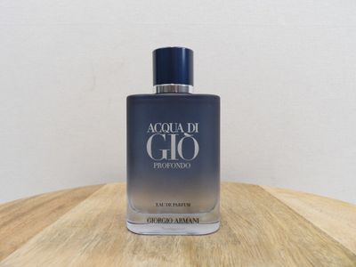 a close up of a bottle of perfume on a wooden table