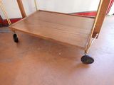 a wooden cart that is sitting on the floor