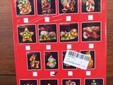 the box is full of christmas ornaments on a wooden table