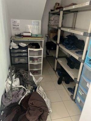 a room that has a lot of clothes on the shelves