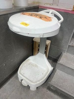 a toilet that has a seat on it in a public restroom