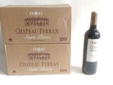 two boxes of wine sitting next to a bottle of wine