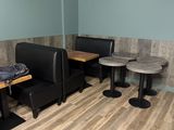 two tables and two booths in the corner of this restaurant