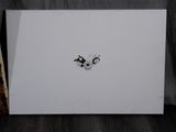 a white card with a picture of two penguins on it
