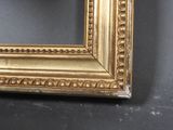 an image of a gold frame on a black wall