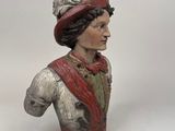 figurine of a bust of a man in a red hat