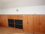a living room with a couch, cabinets and a coffee table