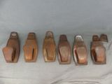 six pieces of wood are lined up in a row on a table