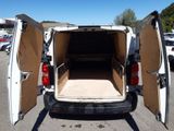 a white van with its doors open in a parking lot
