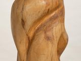 wooden sculpture of a woman ' s head on a white pedestal