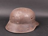 an old helmet is sitting on a black surface