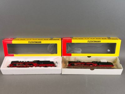 deux wagons rouges et jaunes posés l'un à côté de l'autre sur une table