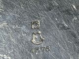 a close up of a metal plate with a number on it