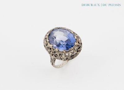 a close up of a ring with a blue stone in it