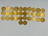 a close up of a bunch of gold coins on a white surface