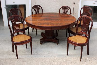 a wooden table with six chairs around it