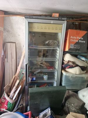 an image of a refrigerator and other junk in a garage