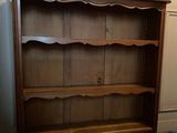 an image of a wooden bookcase with a shelf on top of it