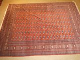 an image of a rug on the floor with a red and blue design