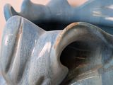 a blue vase that has a large flower inside of it