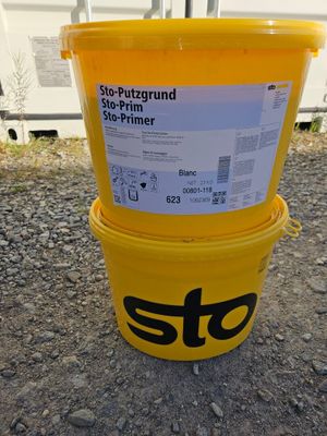 two yellow buckets sitting next to each other on the ground