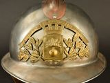 a silver helmet with a gold emblem on it