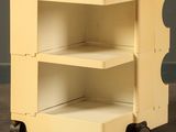 an image of a yellow cart with three shelves on wheels