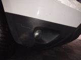 a close up of a car ' s front bumper with a light on