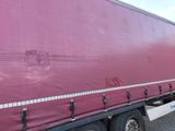 a semi truck with a red cover on the back
