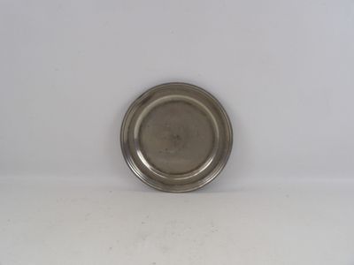 une plaque d'argent sur une surface blanche avec un fond blanc