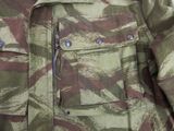 a close up of a camouflage jacket with buttons on it