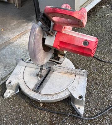 a picture of a red circular saw on the ground