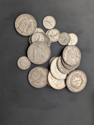 a pile of silver coins sitting on a table
