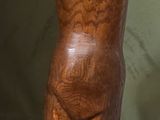 une sculpture en bois représentant un torse féminin posé sur un bloc