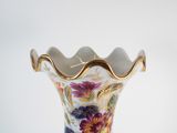 a vase with a floral design on it sitting on a table