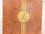 a brown and gold book with a bird on the cover