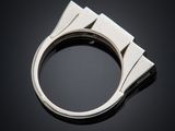 a close up of a silver ring on a black surface