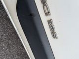 a close up of a car ' s emblem on the front of the car