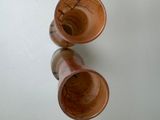 two wooden cups that are sitting on a table
