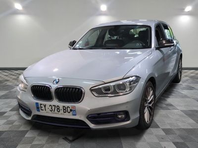 the bmw m140i is parked in the showroom