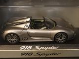 a silver toy car in a display case on a table