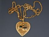 gold plated necklace with a heart shaped pendant with a house in the middle